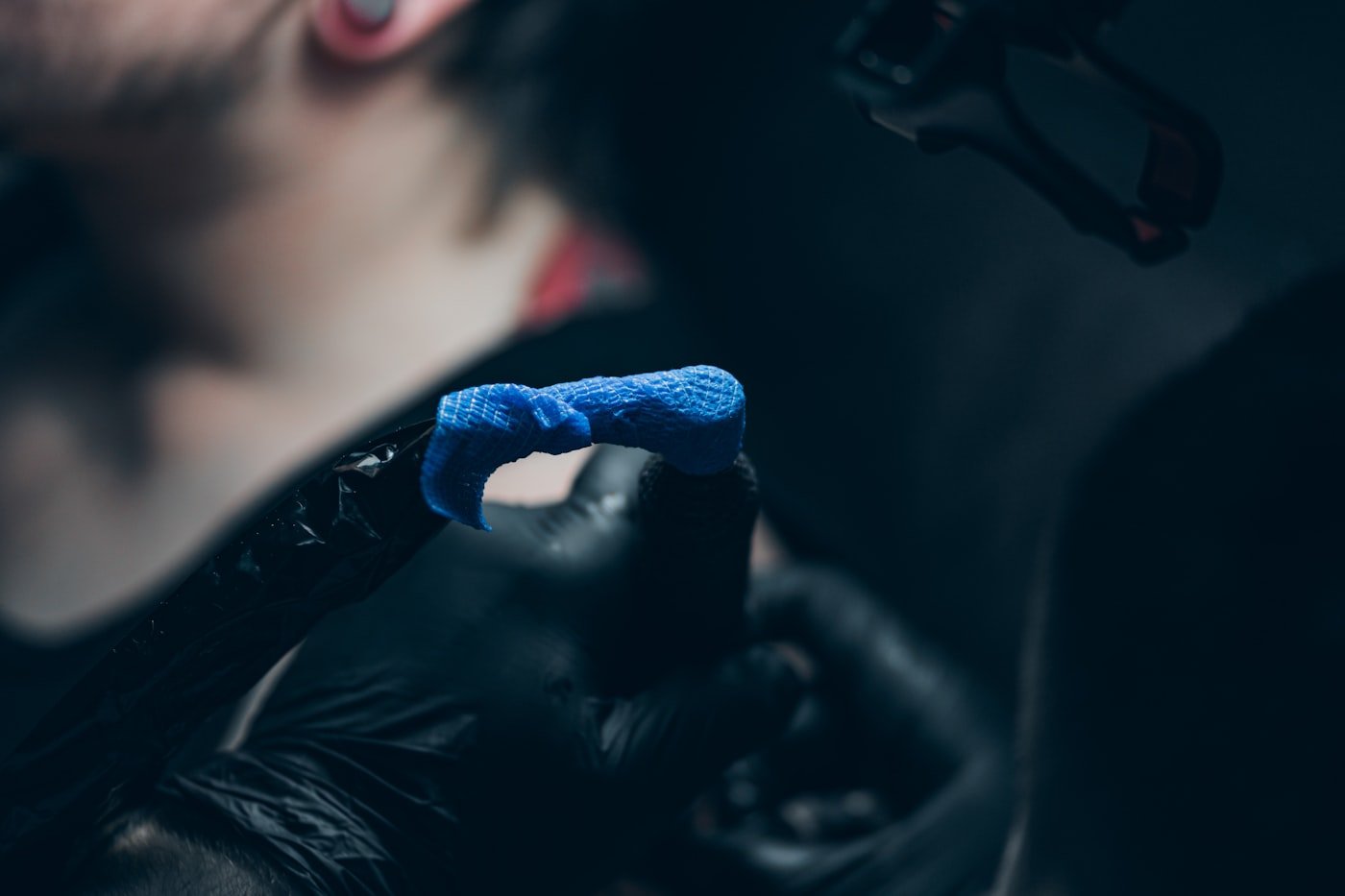 Tattoo artist tattooing a client in a studio session